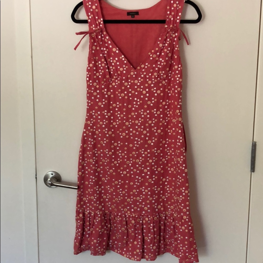 Polka dots coral sleeve less dress.